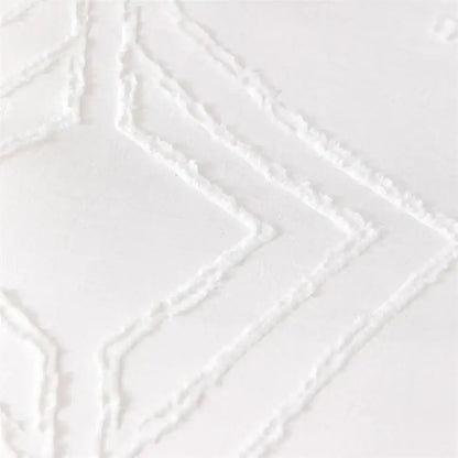 White textured fabric with raised geometric diamond patterns on a quilted duvet cover set for bedroom bedding