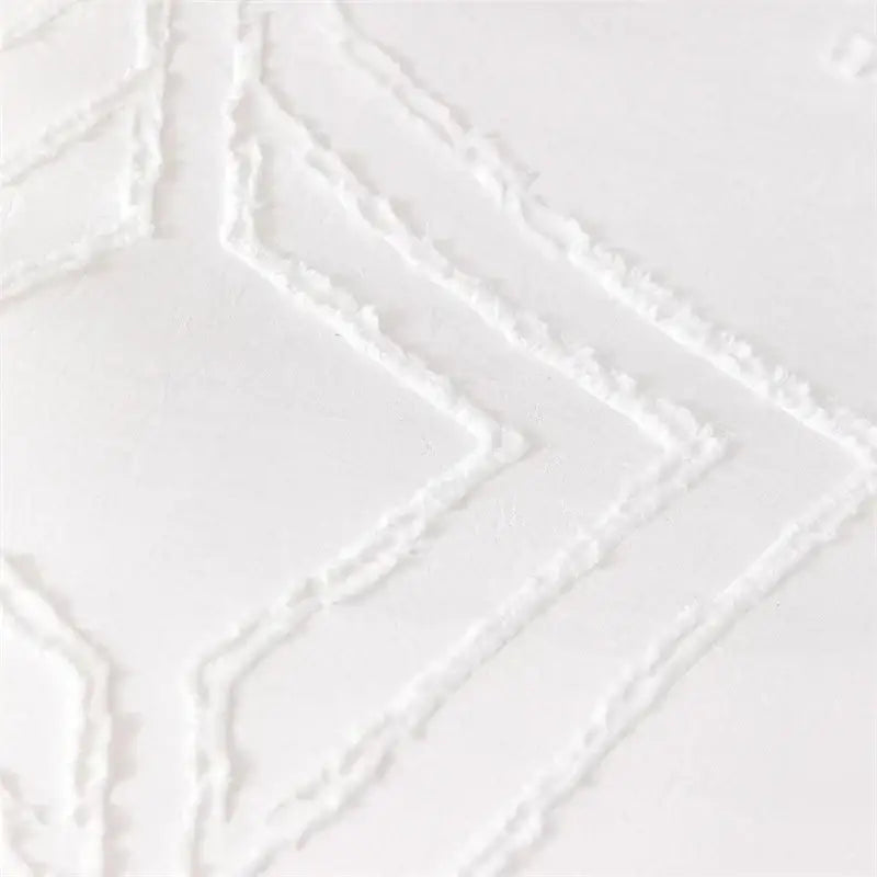 White textured fabric with raised geometric diamond patterns on a quilted duvet cover set for bedroom bedding