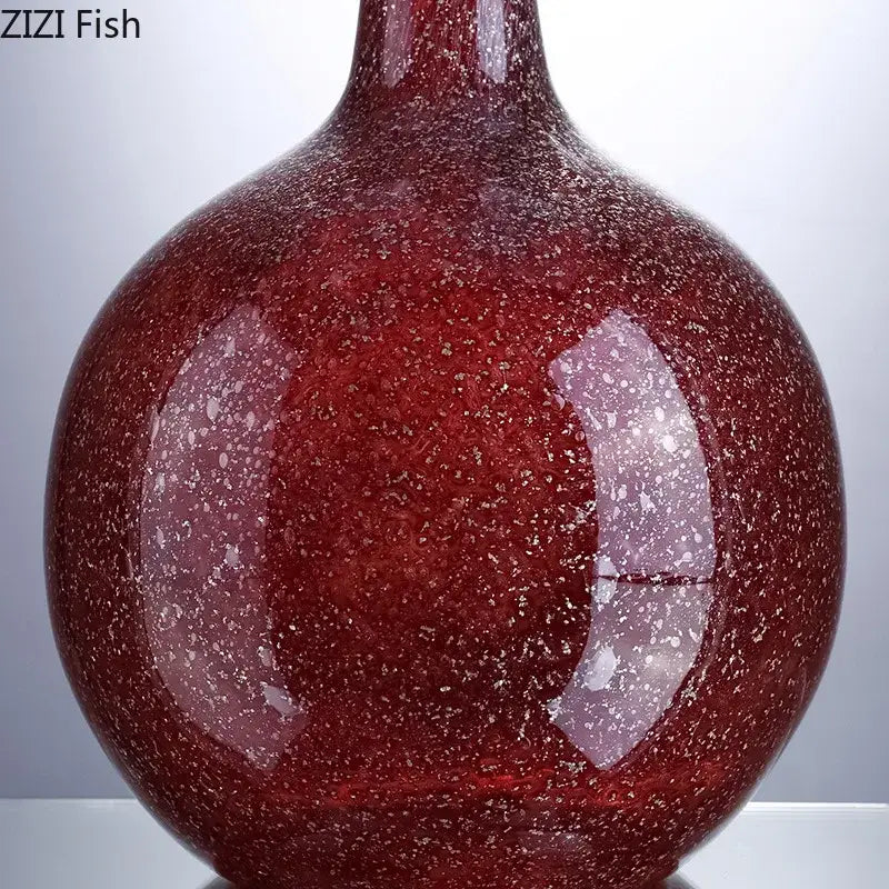 A gilded red glass vase with speckled texture and artificial flowers for decorbites gilded red desk decor
