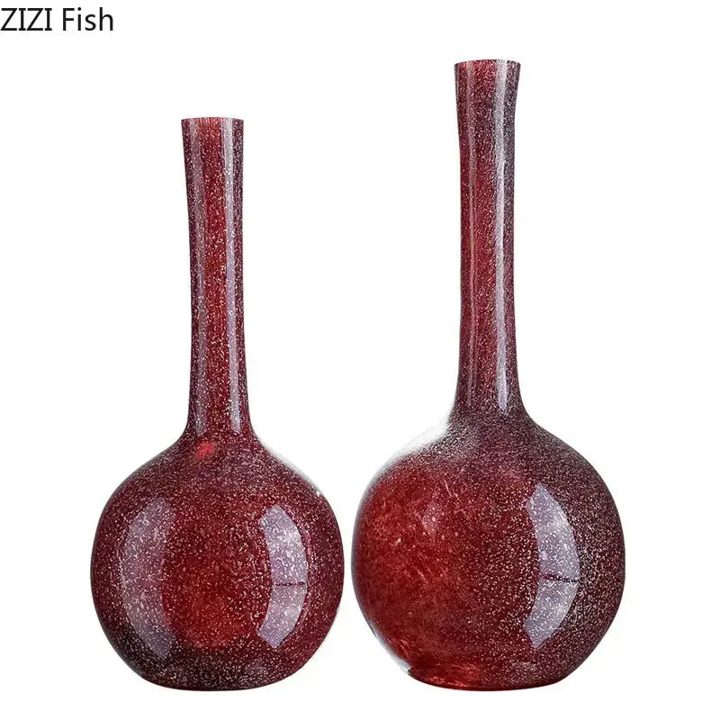 Two elegant gilded red glass vases with slender necks and textured surface featuring artificial flowers decorbites gilded red decor