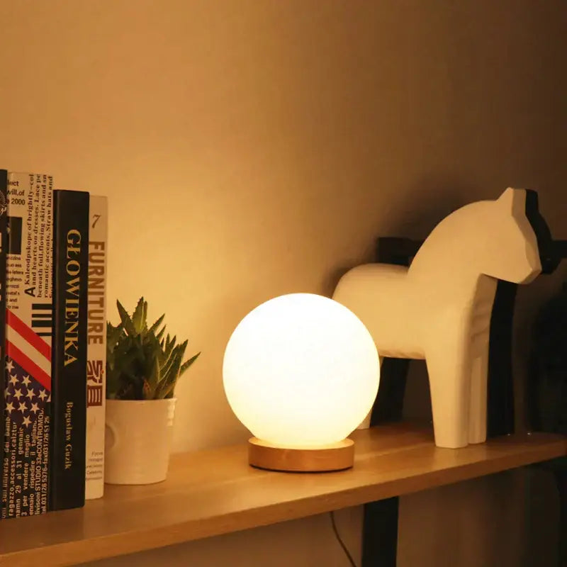 Glass ball led table lamp with wooden base featuring a warm matte white finish for bedroom night light decorbites glass ball