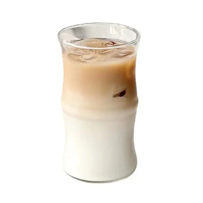 A clear glass bamboo knot mug with bamboo-inspired design filled with layered iced coffee drink