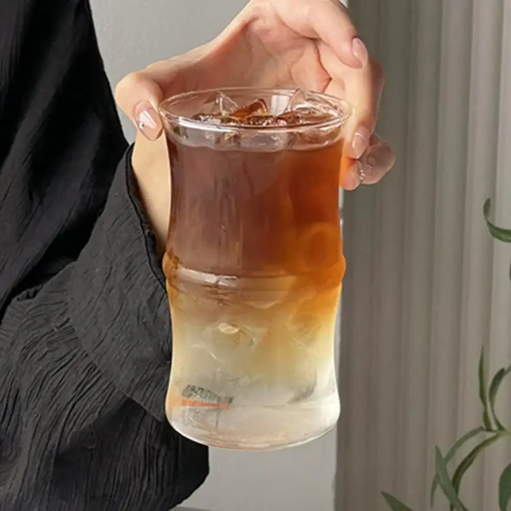 A clear glass bamboo knot mug filled with iced coffee and ice cubes for kitchen use