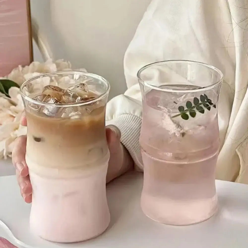 Two clear glass bamboo knot tumblers with frosted pink lower sections designed as kitchen coffee cups