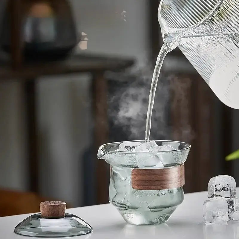 Clear glass gaiwan cup set with wooden handle and lid featuring a textured surface and tea filter for dining room use