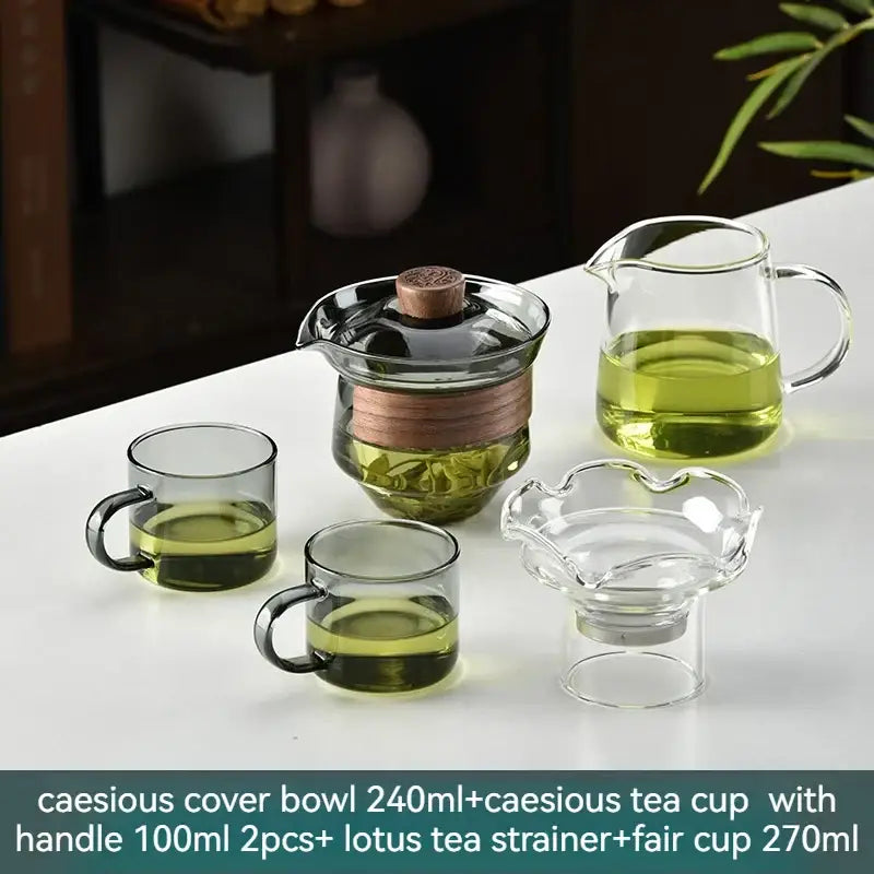 Clear glass gaiwan cup set with wooden lid and copper band includes matching cups and tea strainers for dining room use