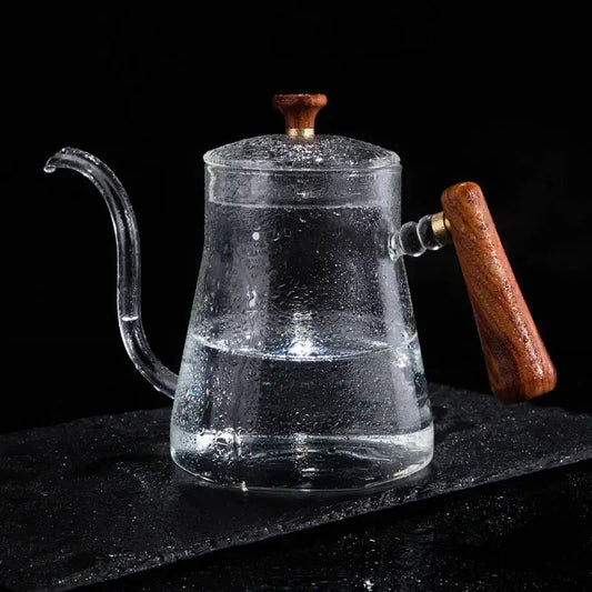 Clear glass goose beak kettle with wood handle and lid knob filled with water by decorbites glass goose for kitchen use