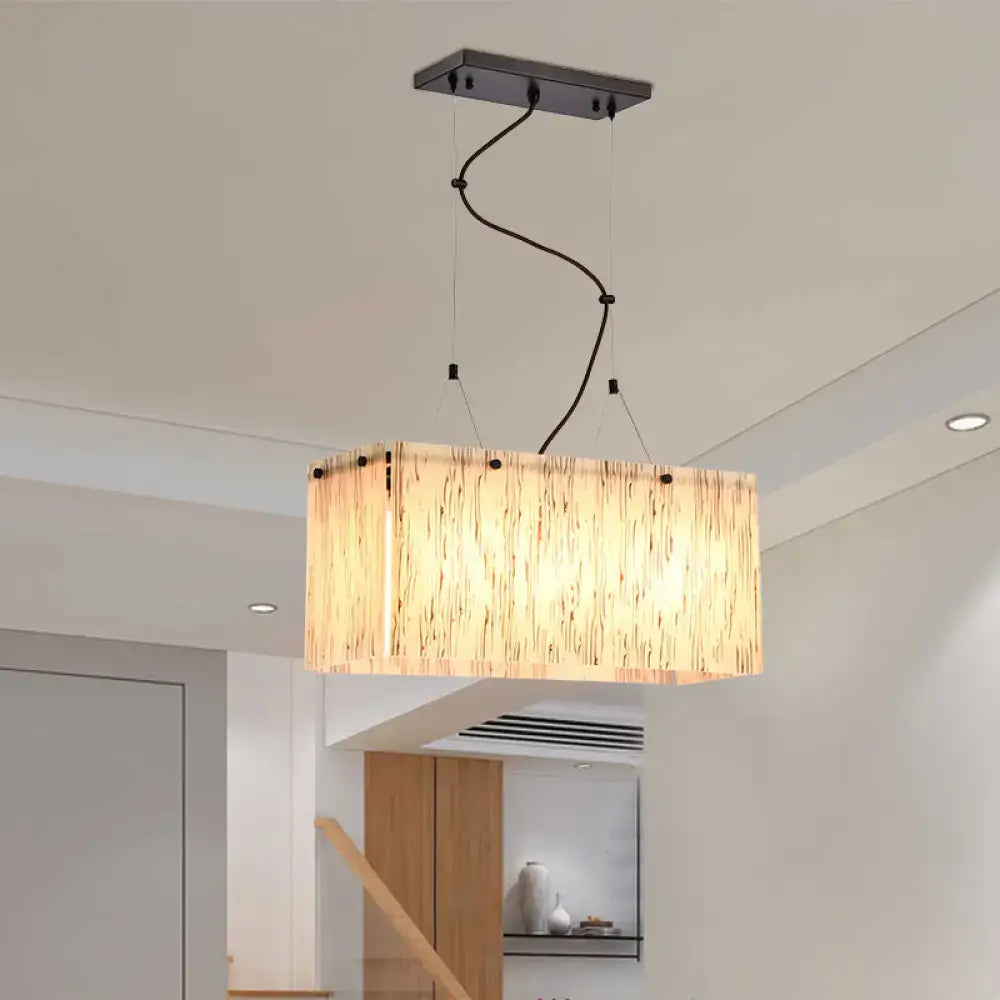 Rectangular pendant light with warm bamboo shade and black hardware in a decorbites beige glass island pendant design