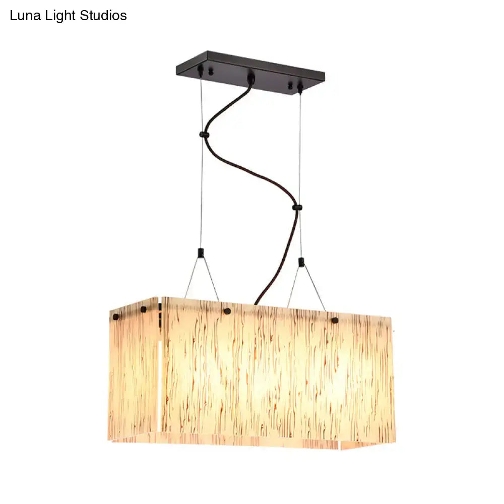 Rectangular beige glass island pendant light with warm textured shade and dark metal mount for dining room lighting