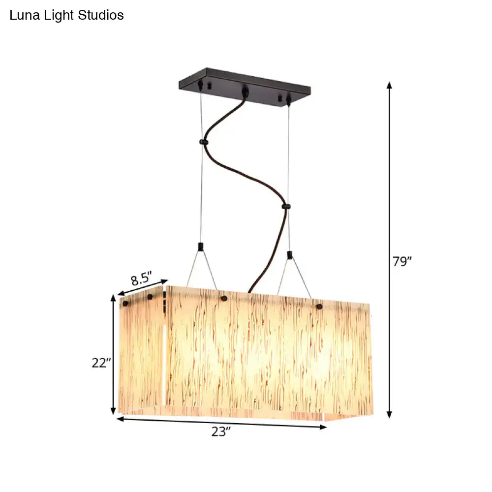 Rectangular pendant light with warm textured wooden shade and black metal hardware in decorbites beige glass island pendant design