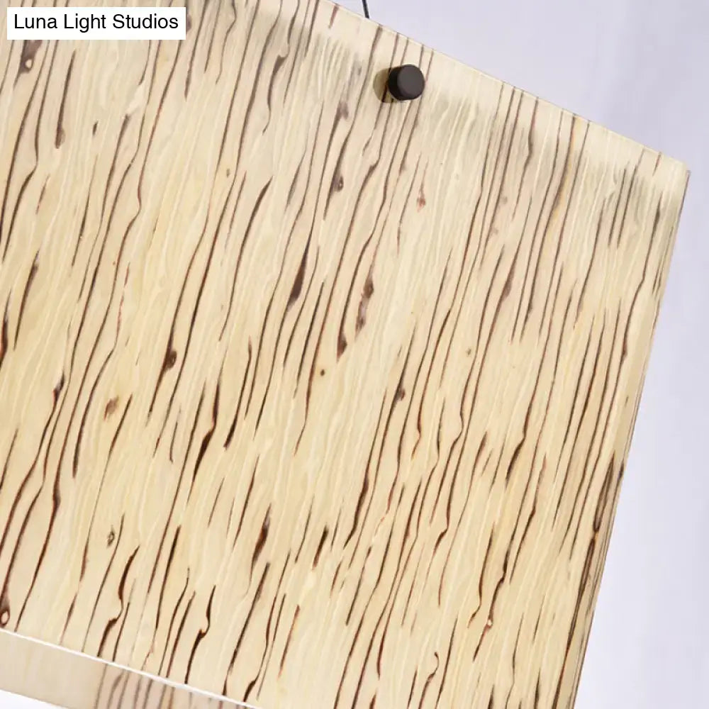 A rectangular wooden panel with beige base and dark brown grain patterns featured in decorbites™ beige glass island pendant light