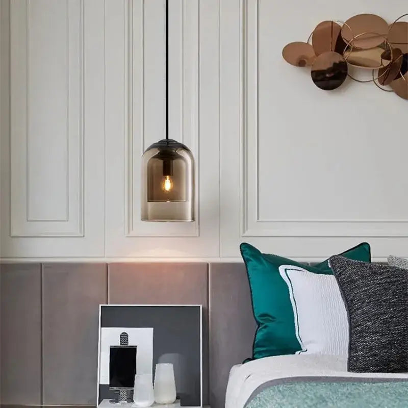 A sleek smoked glass led chandelier pendant light with black cord for dining room or bedroom lighting