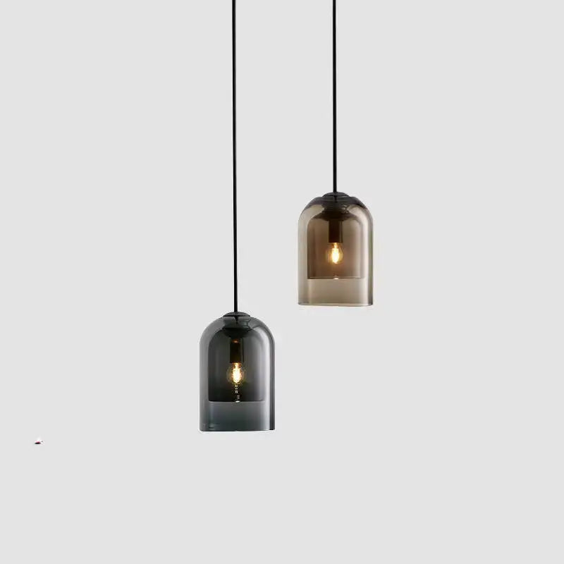 Two sleek smoked glass led chandelier pendant lights with black cords for dining room illumination