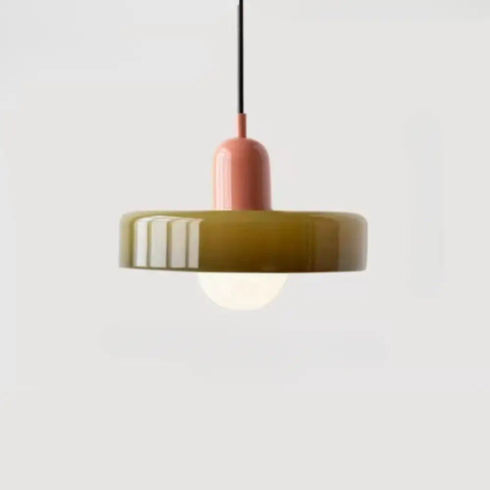 A glass pendant lighting bauhaus style featuring a matte olive-green shade and soft pink stem suspended by a black cord