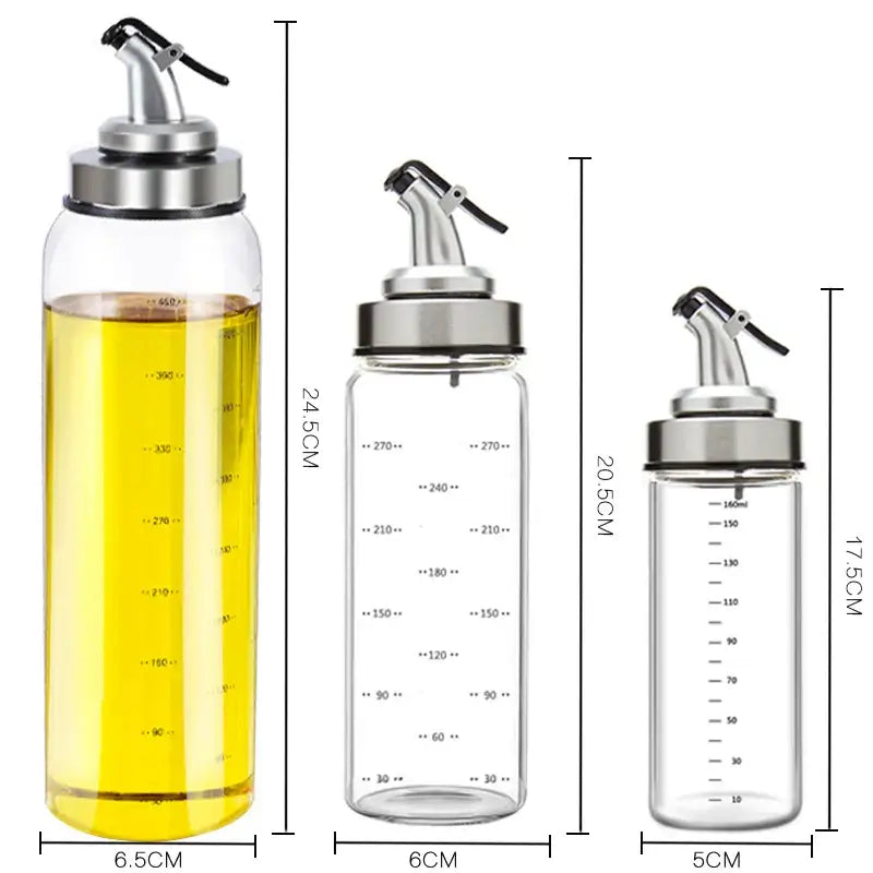 Three clear glass seasoning dispenser bottles with stainless steel spouts and measurement markings in different sizes