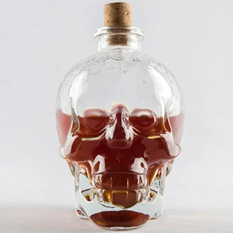 Clear glass skull bottle with cork stopper filled with amber liquid for kitchen crystal wine and vodka decanter