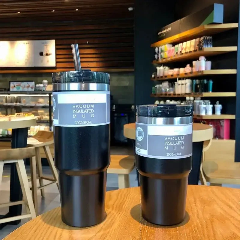 Black double wall insulated stainless steel vacuum mugs with silver lids and labels for kitchen use