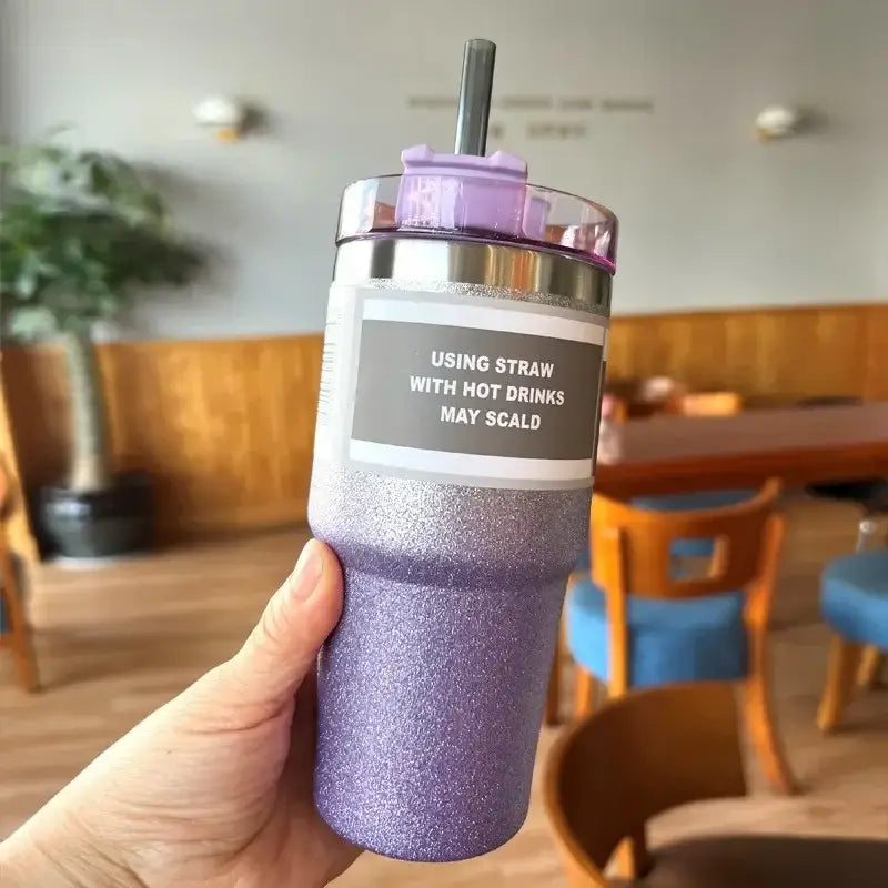 Purple glittery double wall insulated stainless steel water bottle with silver lid and matching straw showing warning label