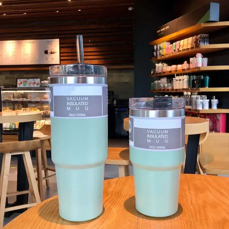 Two mint green double wall insulated stainless steel kitchen mugs with silver lids labeled 30oz and 20oz capacity