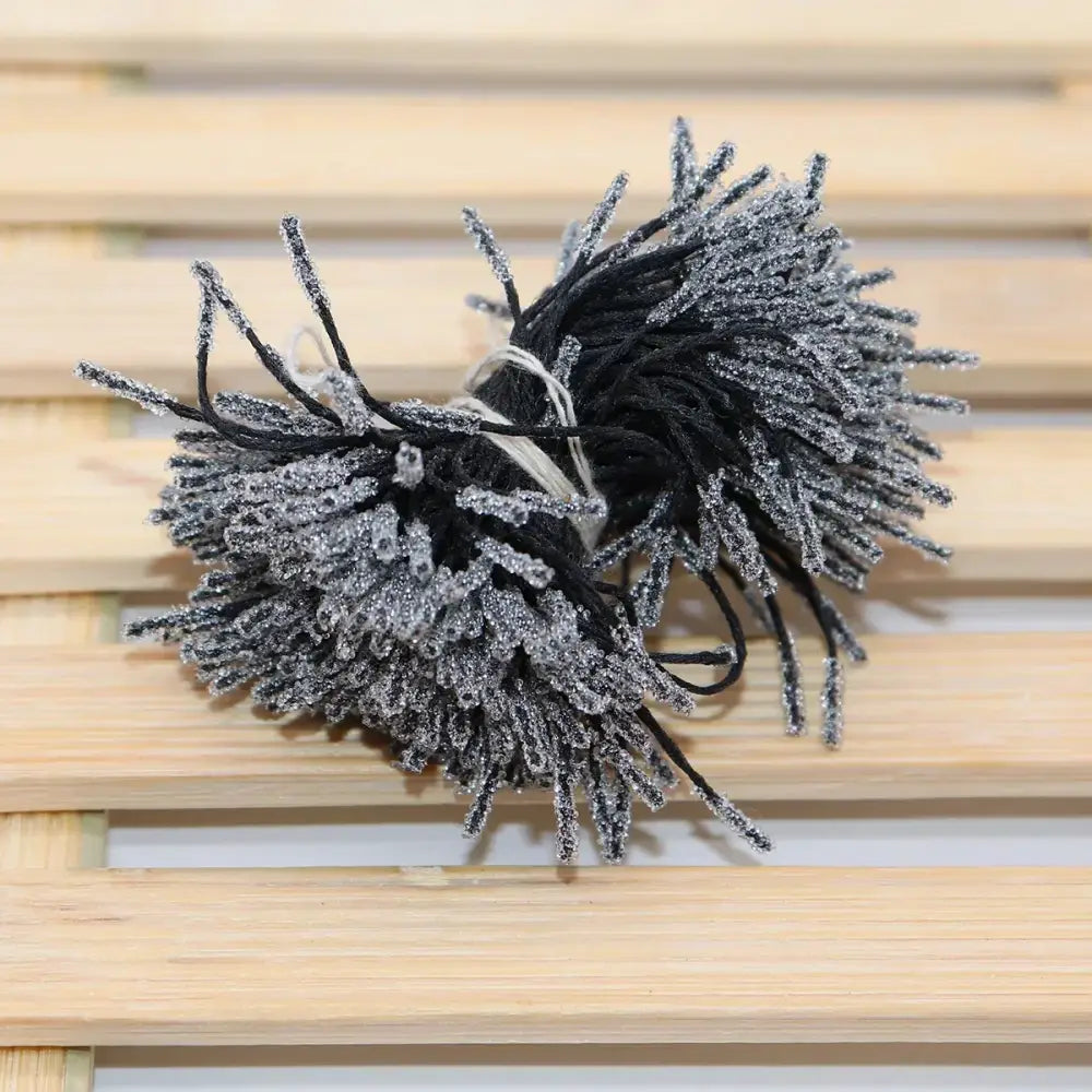 Black and silver glittery yarn pom-poms mini flower stamen hair ties for kids bedroom decor and styling