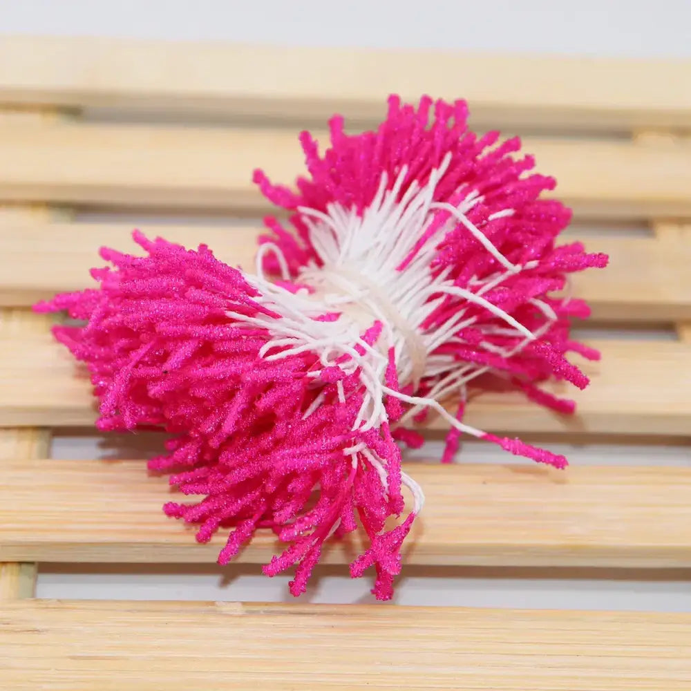 Vibrant pink and white glittery yarn mini flower stamen pom poms for kids bedroom hair ties