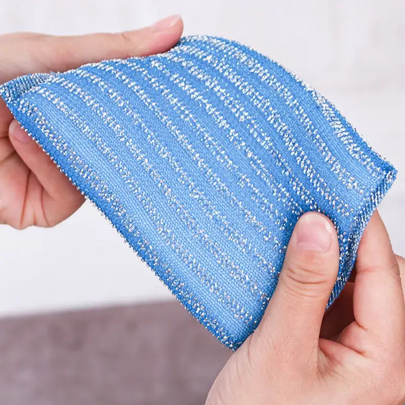 Blue abrasive cleaning sponge with textured striped pattern and metallic flecks in decorbites kitchen cleaning set