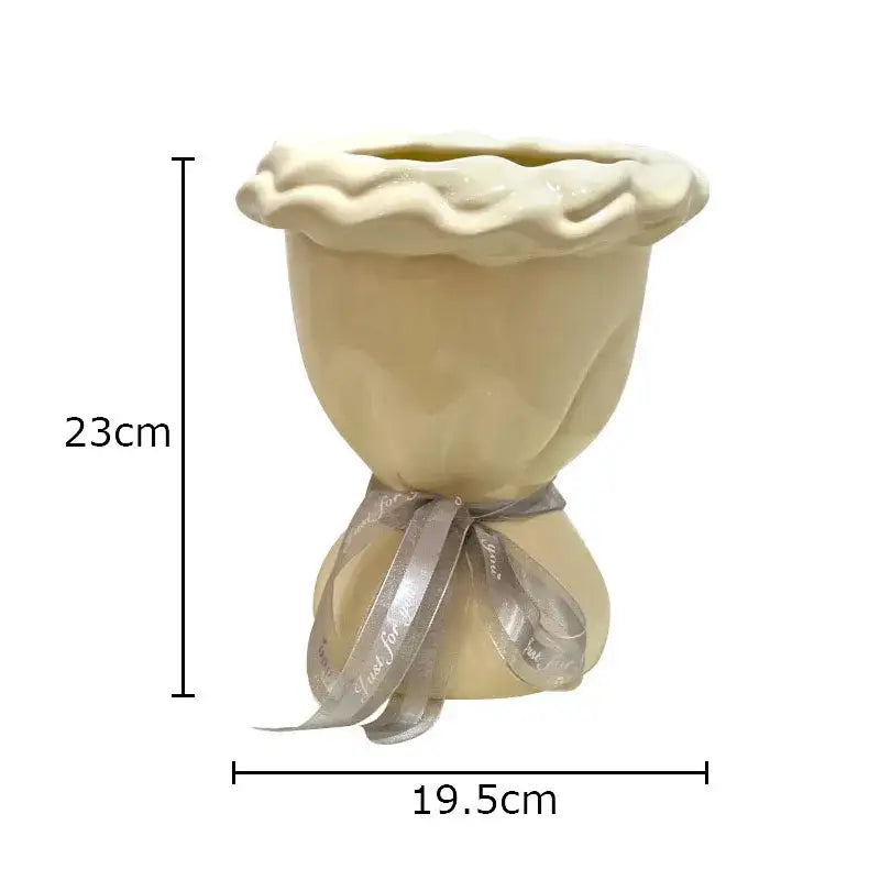 Cream-colored ceramic planter shaped like a pie with scalloped rim and silver ribbon for decorbites ceramic vase artificial flowers bouquet