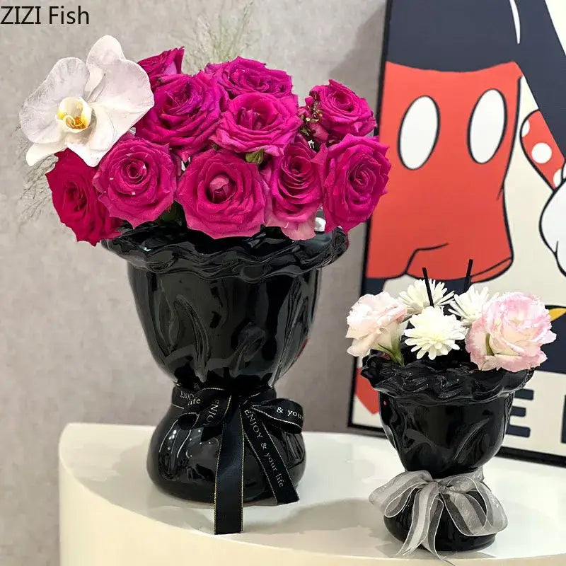Glossy black ceramic vase with scalloped rim and ribbon bow holding pink artificial flowers for decorbites ceramic vase decor
