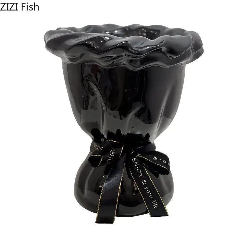 Glossy black ceramic vase with ruffled rim and tied ribbon featuring pink artificial flowers for bedroom decorbites decor