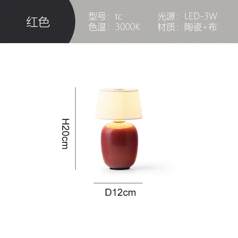 Red ceramics table lamp with fabric shade complementing a glossy black ceramics table lamp for bedroom use
