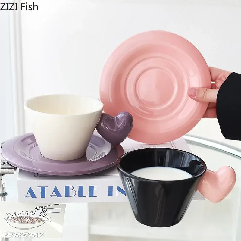 Pink ceramic saucer with concentric ridges paired with glossy black porcelain lovers mug heart shape set