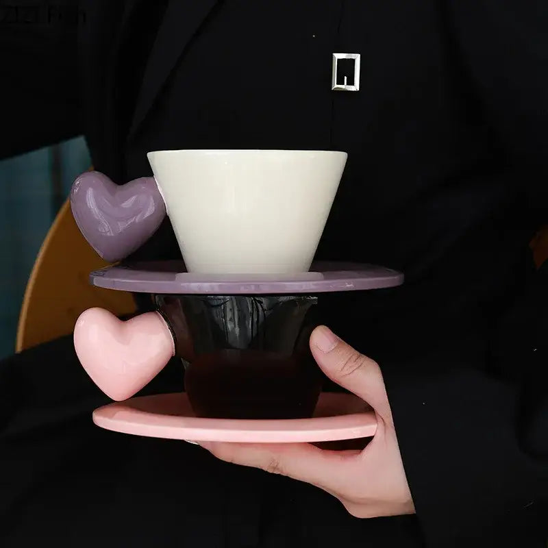 A white ceramic porcelain lovers mug pour over with purple heart shape handle on matching saucer from lovers mug set