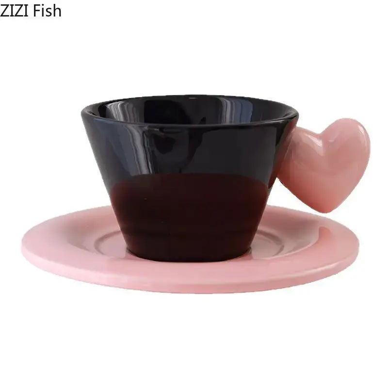 Glossy black ceramic porcelain lovers mug with pink heart shape handle on matching pink saucer lovers mug set