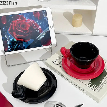 Glossy black and red ceramic heart shape lovers mug set with matching porcelain saucers for dining room use