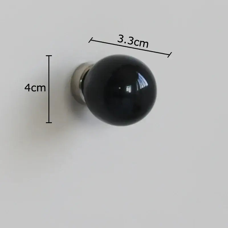 Glossy black spherical ceramic wall hook clothing rack with metallic base for bedroom use measuring 4cm height 3.3cm diameter