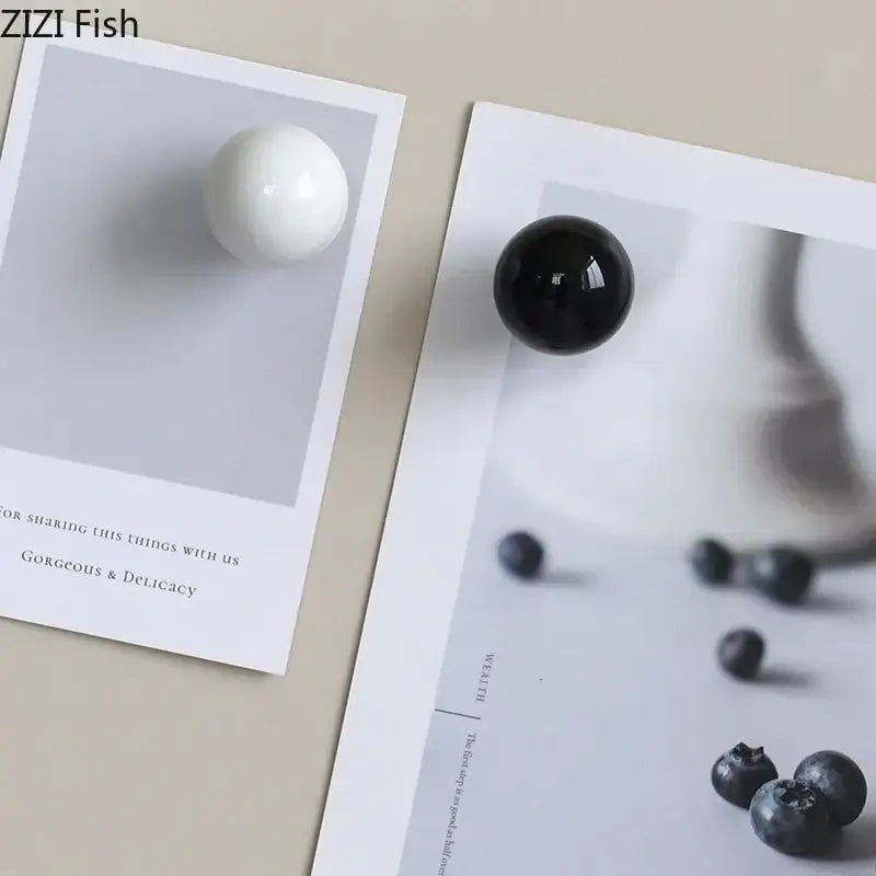 Glossy black and white ceramic wall hook clothing rack with two smooth spherical knobs for bedroom use