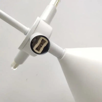 White plastic usb charging port with circular black cover and contacts on the back of atollo black white mushroom lamp