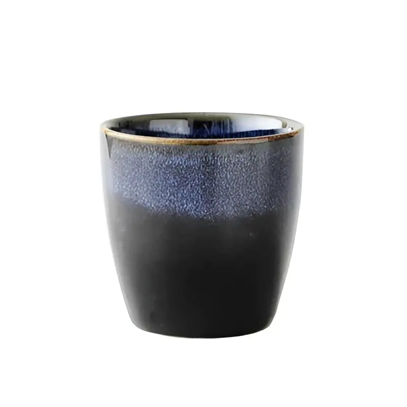 A sleek cylindrical blue ceramic tea cup with gradient glaze in the decorbites blue ceramic tea kettle set