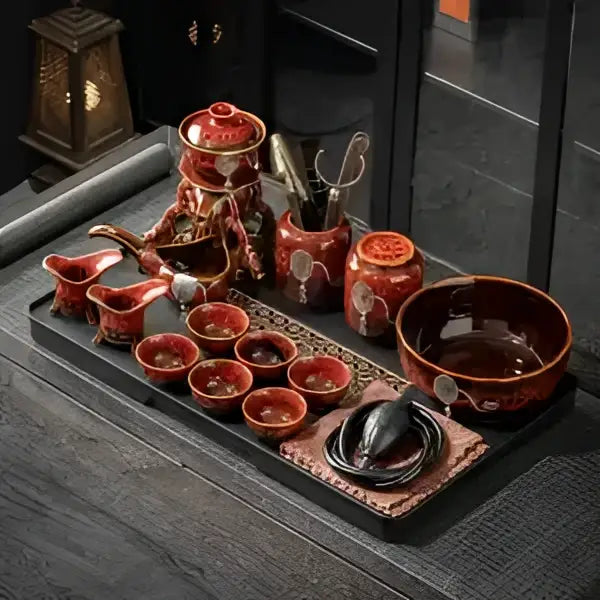 Glossy earth tone red ceramic magnetic rotating tea set with intricate gold patterns featuring decorbites dragon teapot