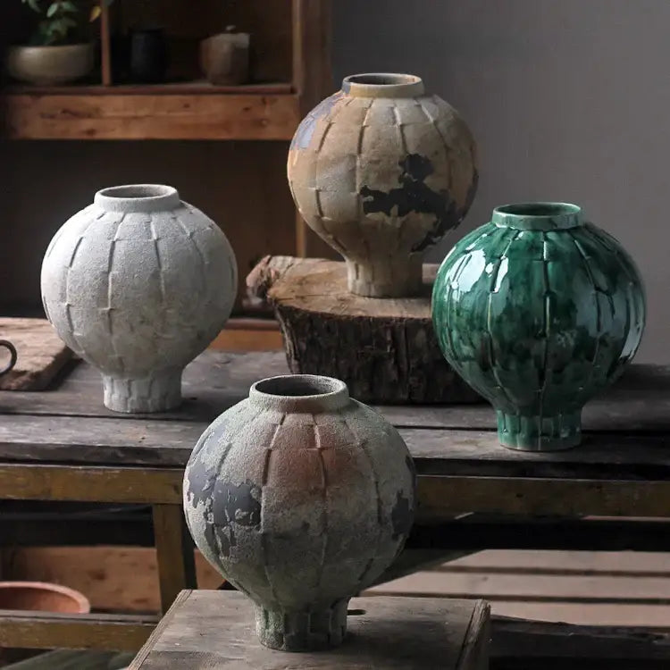 Handcrafted green ceramic spherical vase with ribbed texture and earthy glazes for living room decor