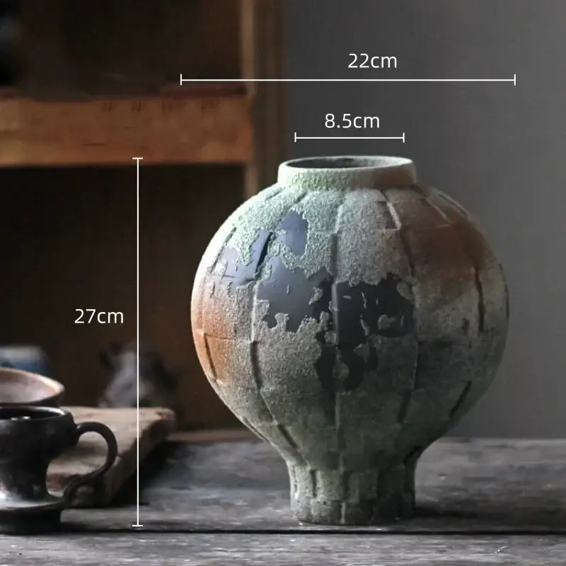 Glossy green ceramic spherical vase with textured earthy green and black cracked glaze for living room decor