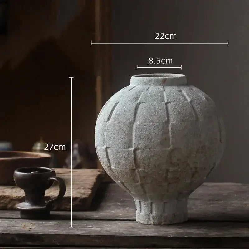 Light gray ceramic spherical vase with textured geometric grid pattern for living room decor alternative to green ceramic spherical vase
