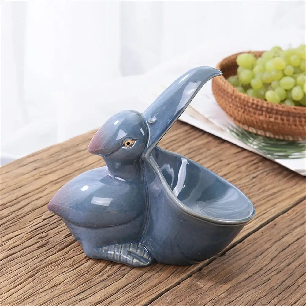 Glossy blue ceramic animal storage pelican dish with curved beak and detailed eyes from decorbites ceramic animal line