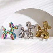 Three glossy balloon dog ceramic figurines in iridescent rainbow, chrome silver, and gold finishes for living room decor