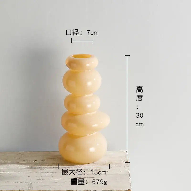 Cream-colored glossy ceramic vase with stacked rounded segments perfect for pebble stack floral arrangement