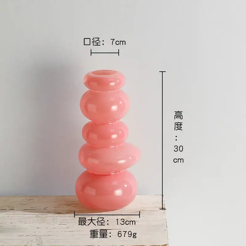 A translucent pink glass vase with a glossy pebble stack floral design for living room decoration