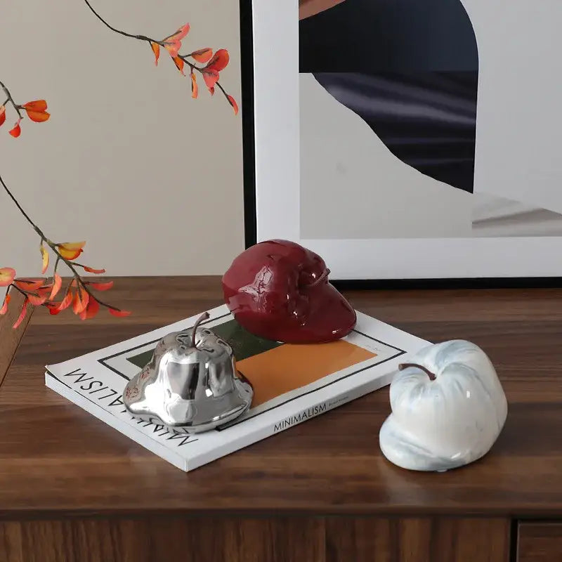 Glossy red ceramic melting apple sculpture with smooth reflective surface and subtle embossed details for living room decorbites abstract melting apple decor