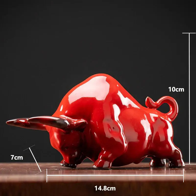 Glossy red ceramic bull figurine with detailed sculpting perfect for office decor by decorbites bull figurine