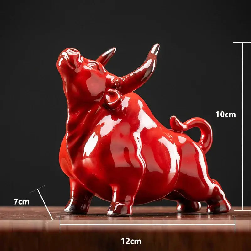 Glossy red ceramic bull figurine with stylized horns by decorbites for office decor and animal statue collection