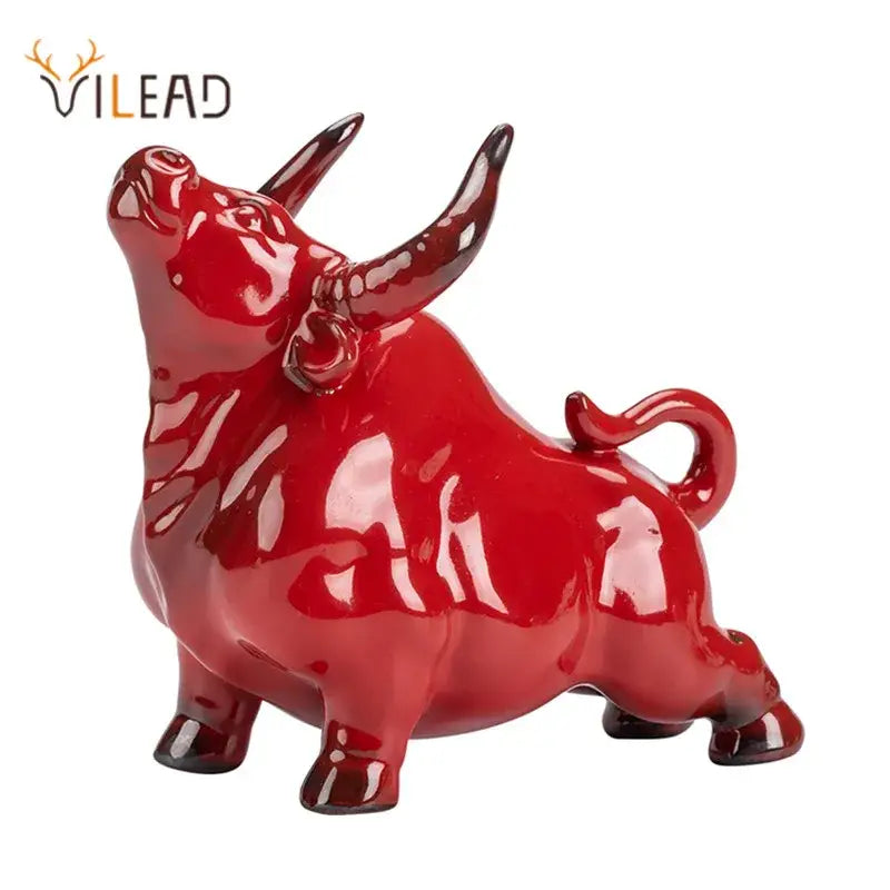 Glossy red ceramic bull figurine with polished horns and curved tail by decorbites for office decor